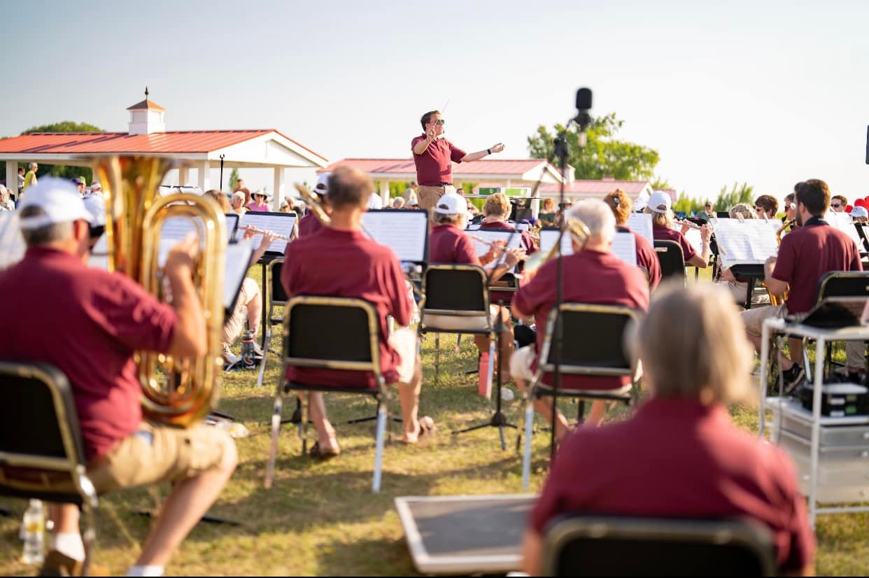 A picture of CMU student Ryan Biller conducting the Manistee Community Band.