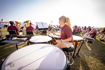 A picture of the Manistee Community Band rehearsing outdoors.