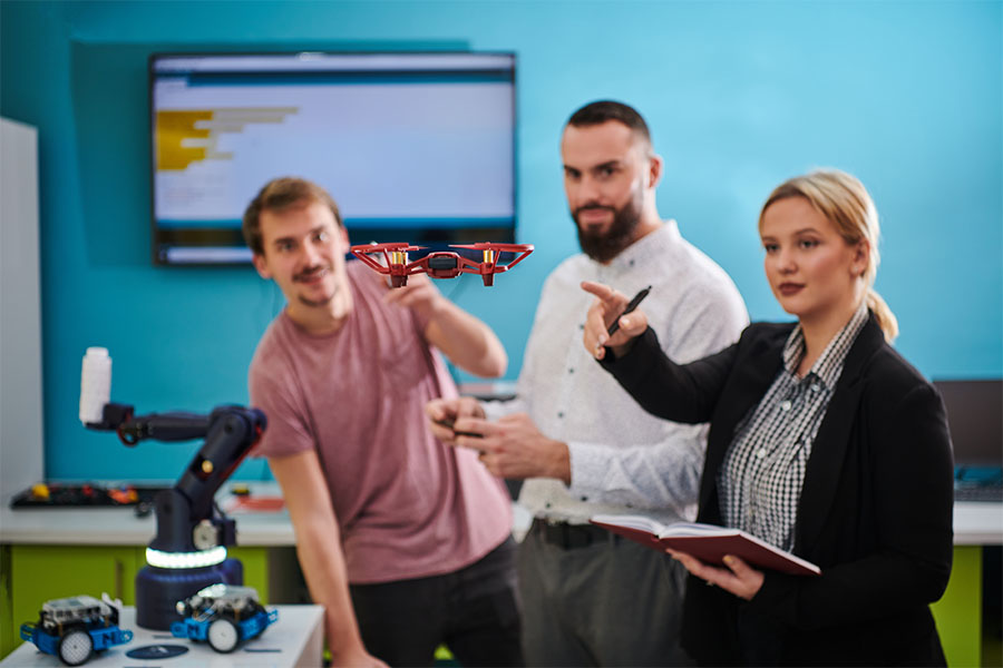 employees in a conference room with a drone