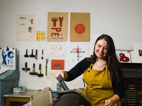 A woman working in a studio art room.