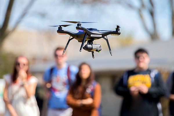 A closeup of a drone as it first takes flight.