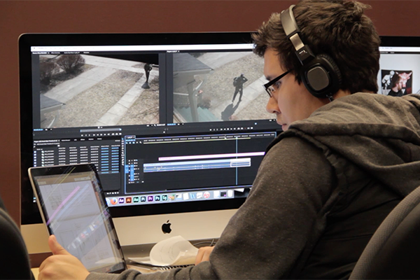 A student works on editing a film that he has created.