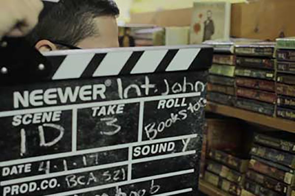 A closeup of a movie slate about to be used during the filming of a student project.