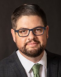 Headshot of Chad Livengood with a dark grey backdrop.