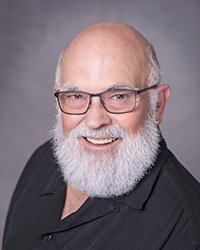 Headshot of Gary Lico with a grey backdrop.