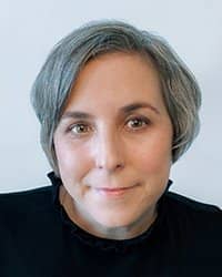 Headshot of Tricia Hoover on a light grey backdrop.