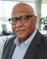 Picture of a man wearing glasses and a suit.
