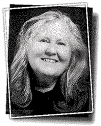 Greyscale headshot of Kelly Kolhagen. There's a crooked white frame around the picture.