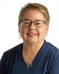 Headshot of Kim Clarke on a white backdrop.