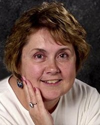 Headshot of Monetta Richey Harr with a dark grey backdrop.