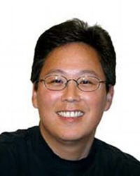 Headshot of Wayne Kamidoi on a white backdrop.