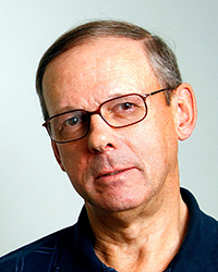Headshot of John Hartman on a light grey backdrop.