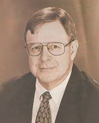 Headshot of Jim Wojcik, a greyscale image cut from a newspaper.