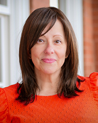 20250626_MHoF_LYLitwiller_001_200x250 Headshot of Lisa Yanick Litwiller in front of a brick building with white frames windows.