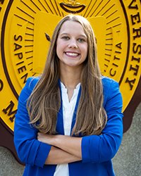 Headshot of Ella Pierzecki standing in front of the CMU seal