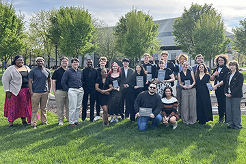 The entire forensics team standing on the lawn