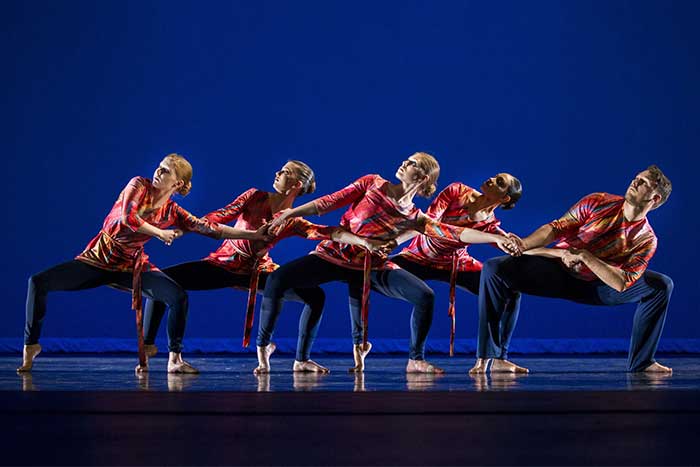 Group of CMU University Theatre Dance Company students performing a dance up on the stage on the campus of Central Michigan University.