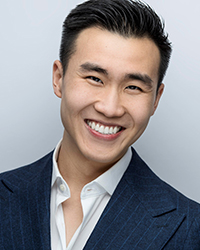 Headshot of Brandon Chu on a soft grey backdrop.