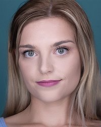 Headshot of Meg Johns on a blue backdrop.