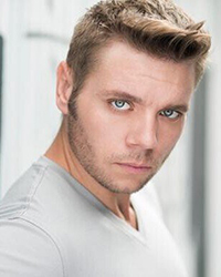 Headshot of Nate Hackmann with an abstract white and green backdrop.