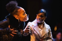 Close-Up of two Central Michigan University students while they do a Song for Coretta performance up on stage in the Bush Theatre.