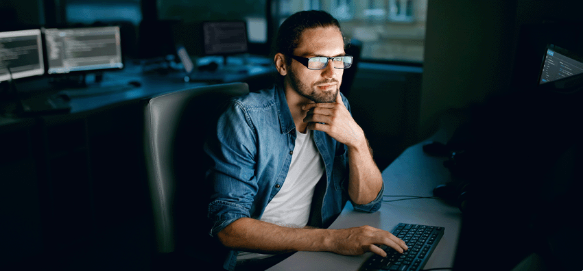 Man sitting at a desk working on a computer