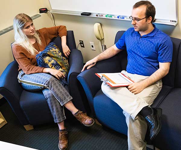 Male conducting and counseling session with a young woman