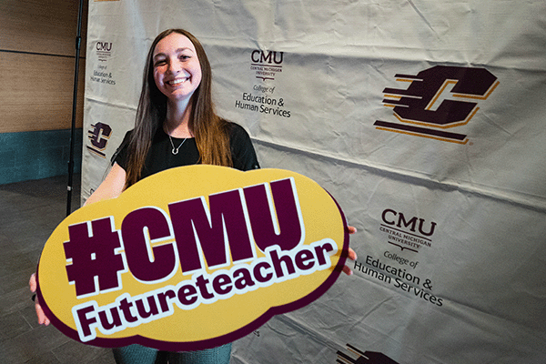 Future educator holding a sign #CMU Future Teacher