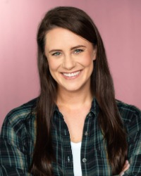 a headshot of Callie Santillana wearing a green flannel shirt against a pink background.