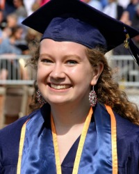 Kendahl Miller wearing a blue graduation cap and gown.