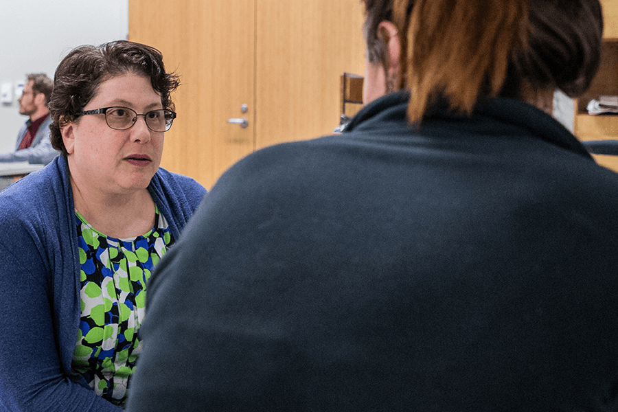 Faculty member Sheri Pickover talking with a student