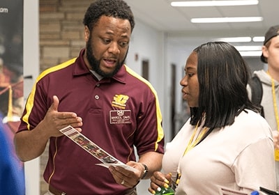 Academic advisor explaining something to a student