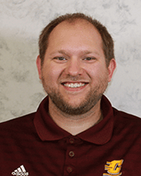 Bob Dvorak smiling for a professional headshot photo against a gray backdrop.