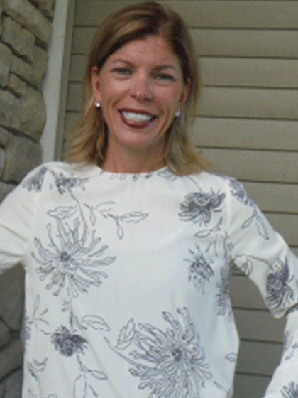 Anne Hornak wearing a white long sleeve top.