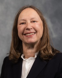 Professional headshot of Krystyna Nowak-Fabrykowski against a grey background.