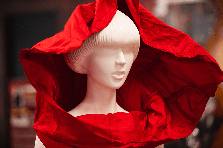 headshot of red fashion garment on mannequin
