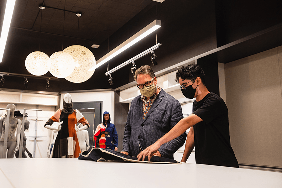 faculty member discussing garment design with student
