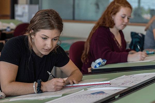 girl student at a drafting table