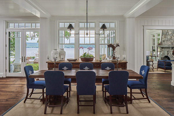 Alum_Design_Lake_Home_600x400 a dining room with windows that overlook a lake with a 8 person table and chairs