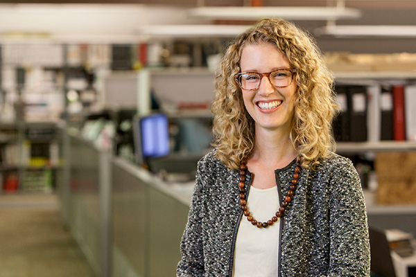 JulieBraam_600x400 a woman with shoulder length, curly, blond hair and glasses smiling at the camera