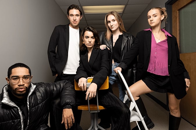 A group of fashion students pose for the cover of a magazine.