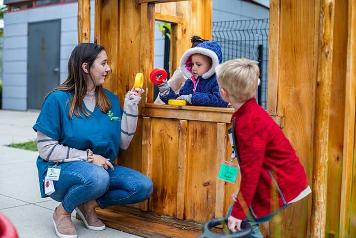 kids interacting with adult on playground