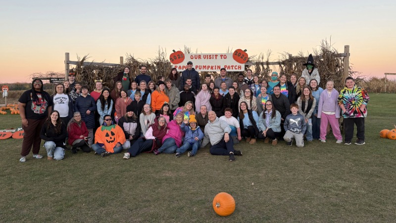 A large group of students and CTC participants outside at a pumpkin patch.