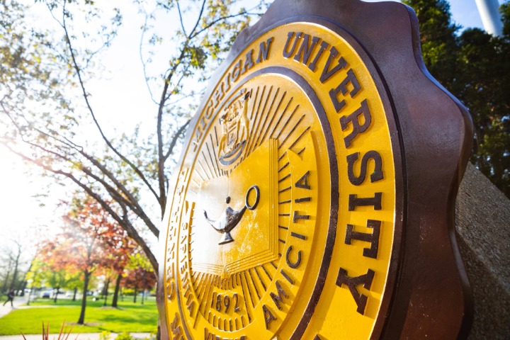 The CMU Seal outside during the day.