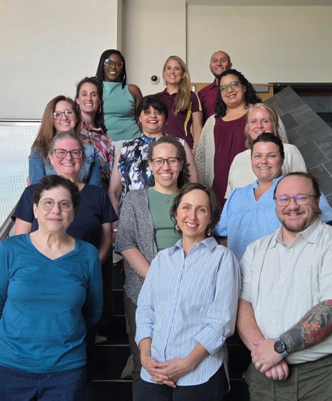 A group of counseling staff and faculty standing on a staircase posing for a photo.