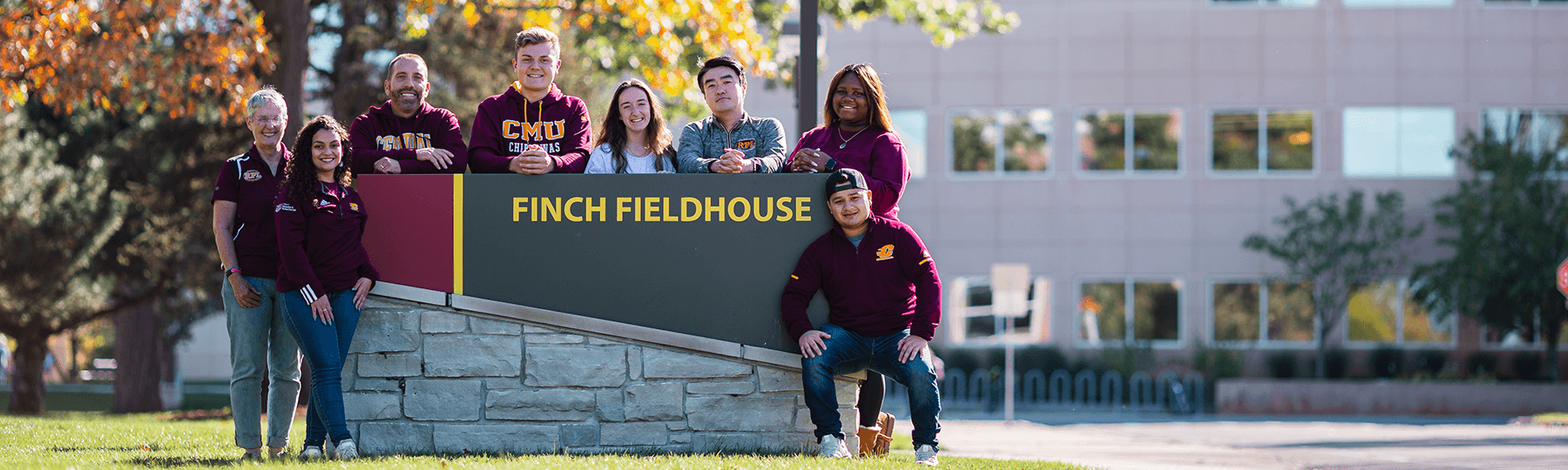 Group of RPL students and faculty by Finch sign in the fall