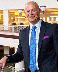 Jeremy Bond DET graduate 200x250 Jeremy Bond, a graduate from the Doctorate in Educational Technology program at Central Michigan University, in a suit coat, tie and button up shirt.