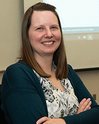 katie_baleja DET graduate Katie Baleja, a graduate from the Doctorate in Educational Technology program at Central Michigan University, in a teal sweater and black and white blouse.
