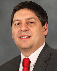 Robert Norman 2020 DET graduate Robert Norman, a graduate from the Doctorate in Educational Technology program at Central Michigan University, in a suit coat, red tie and white button up.