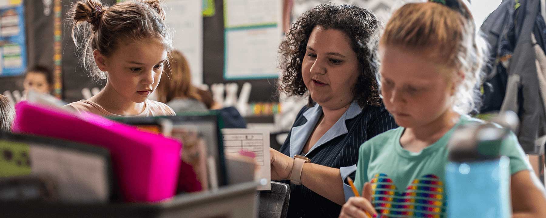 Student teacher in the classroom with two students